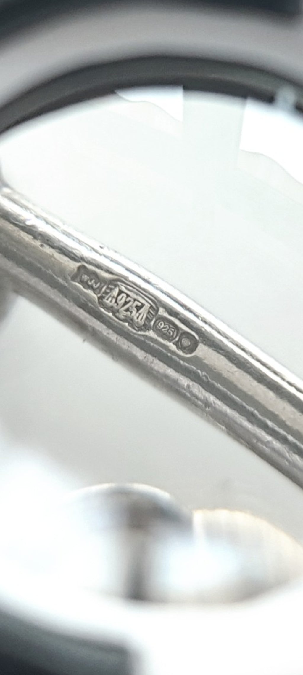 A silver necklace with blue glass heart